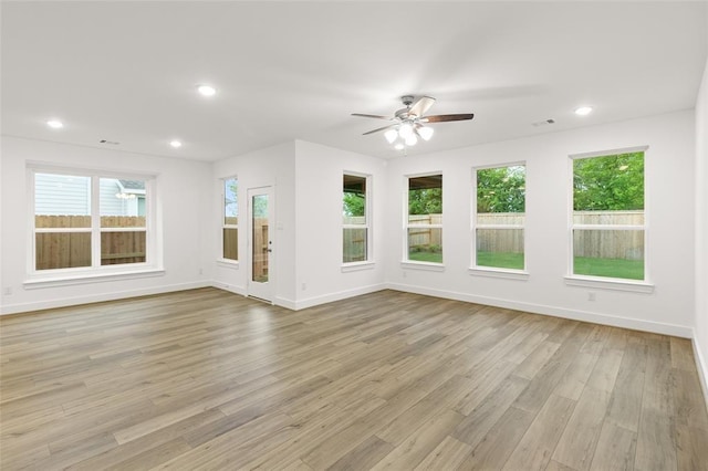8307 Red Shiner Way, Fulshear, TX 77441 - unfurnished living room with healthy amount of natural light, a ceiling fan, light wood-type flooring, and recessed lighting