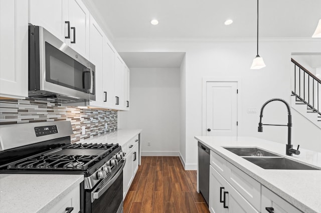 13415 Scott St, Houston, TX 77047 - kitchen with appliances with stainless steel finishes, a sink, baseboards, tasteful backsplash, and crown molding