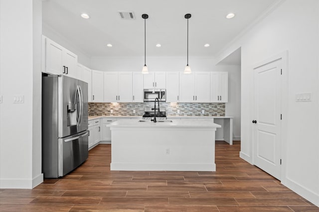 13415 Scott St, Houston, TX 77047 - kitchen featuring appliances with stainless steel finishes, light countertops, decorative backsplash, white cabinetry, and crown molding