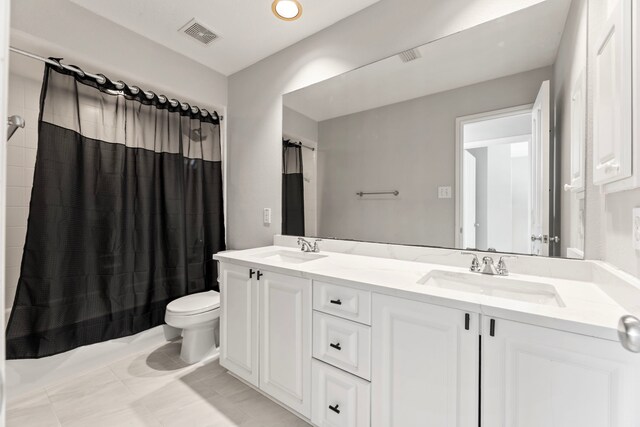 bathroom featuring toilet, double vanity, and shower / bath combination with curtain
