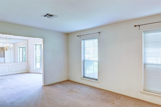 7907 Aleta Dr, Spring, TX 77379 - spare room with healthy amount of natural light, carpet flooring, and a chandelier