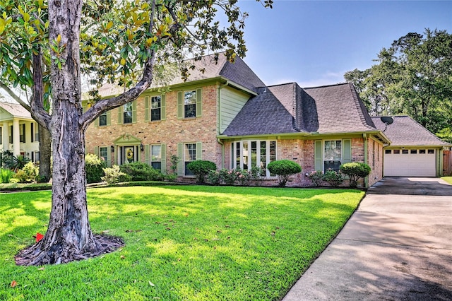 7907 Aleta Dr, Spring, TX 77379 - view of front of property with brick siding, a front yard, roof with shingles, driveway, and an attached garage