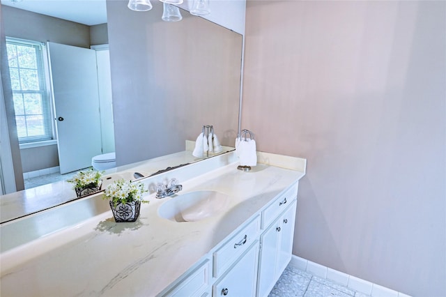 7907 Aleta Dr, Spring, TX 77379 - bathroom featuring vanity, baseboards, toilet, and tile patterned flooring