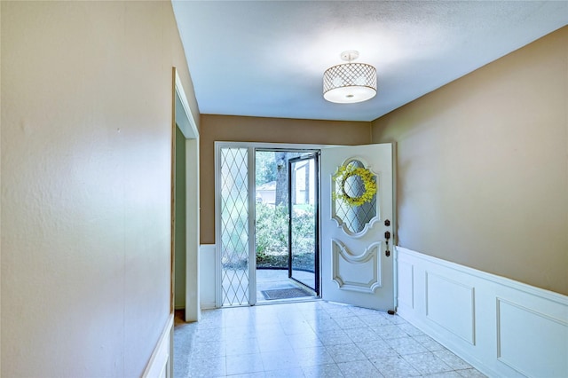 7907 Aleta Dr, Spring, TX 77379 - entrance foyer with wainscoting and a decorative wall