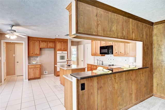7907 Aleta Dr, Spring, TX 77379 - kitchen with black appliances, a textured ceiling, tasteful backsplash, a ceiling fan, and baseboards