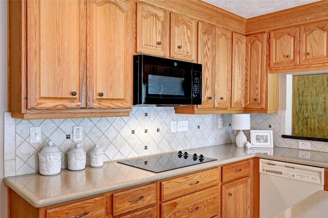 7907 Aleta Dr, Spring, TX 77379 - kitchen with black appliances, light countertops, and decorative backsplash