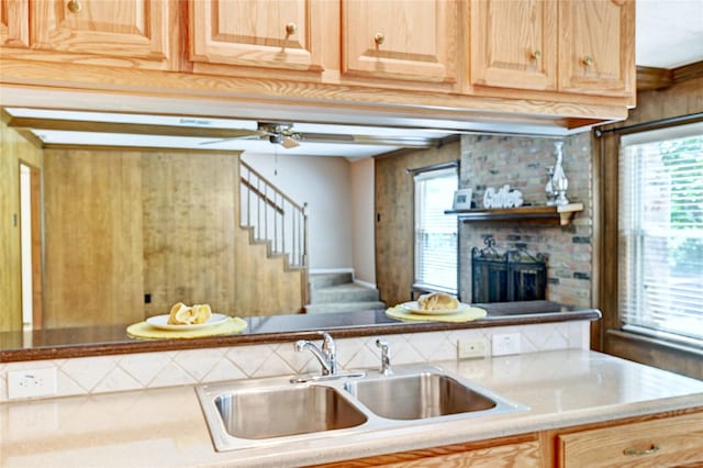 7907 Aleta Dr, Spring, TX 77379 - kitchen with a sink, a fireplace, baseboards, light brown cabinets, and a ceiling fan