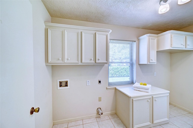 7907 Aleta Dr, Spring, TX 77379 - laundry area with electric dryer hookup, cabinet space, hookup for a washing machine, baseboards, and light tile patterned flooring