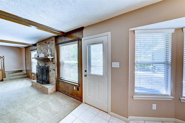 7907 Aleta Dr, Spring, TX 77379 - unfurnished living room with baseboards, a brick fireplace, stairway, and a textured ceiling