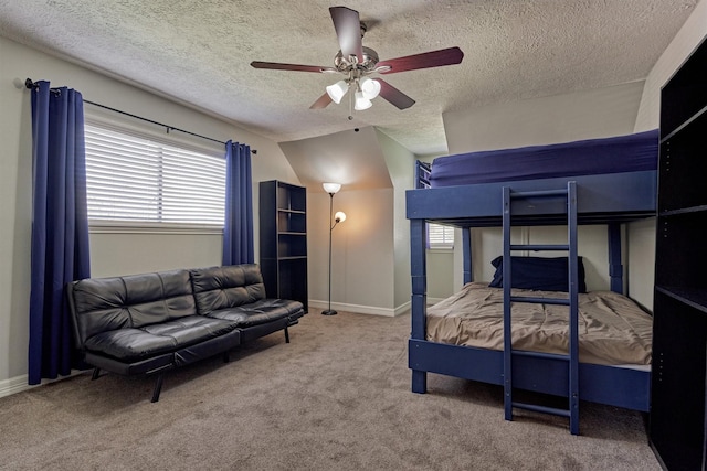 bedroom featuring a textured ceiling, carpet floors, baseboards, ceiling fan, and vaulted ceiling