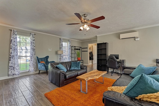 living area featuring an AC wall unit, wood finished floors, a ceiling fan, a textured ceiling, and baseboards