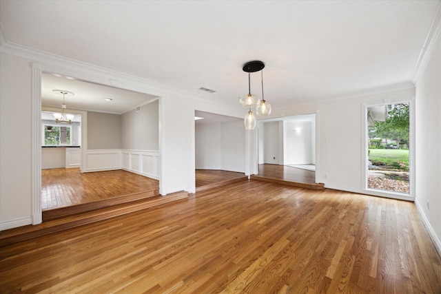 14303 Bonney Brier Dr, Houston, TX 77069 - unfurnished living room featuring plenty of natural light, ornamental molding, a chandelier, and light wood-type flooring