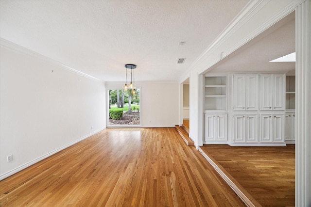 14303 Bonney Brier Dr, Houston, TX 77069 - unfurnished dining area with a chandelier, light wood-style floors, baseboards, ornamental molding, and built in features