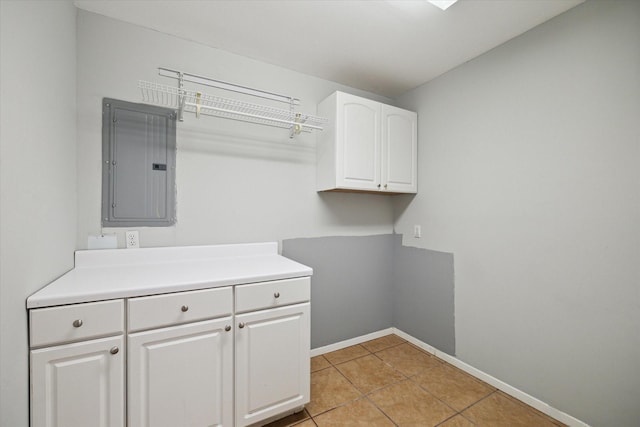 14303 Bonney Brier Dr, Houston, TX 77069 - laundry area featuring electric panel, light tile patterned floors, and baseboards