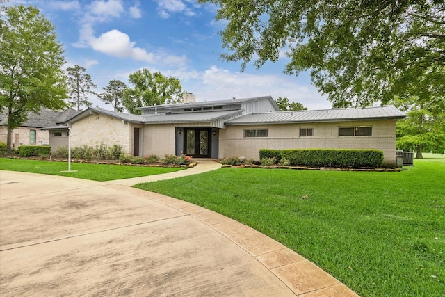14303 Bonney Brier Dr, Houston, TX 77069 - mid-century home with french doors, brick siding, a chimney, a front lawn, and metal roof