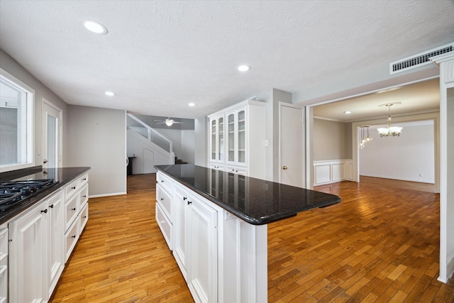 14303 Bonney Brier Dr, Houston, TX 77069 - kitchen featuring light wood-style floors, a chandelier, white cabinetry, a center island, and recessed lighting