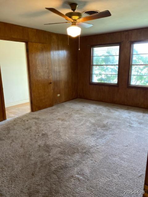 1912 18th St, Huntsville, TX 77340 - unfurnished room featuring carpet, ceiling fan, and wooden walls