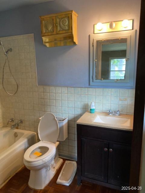 1912 18th St, Huntsville, TX 77340 - bathroom featuring tile walls, tub / shower combination, toilet, vanity, and backsplash