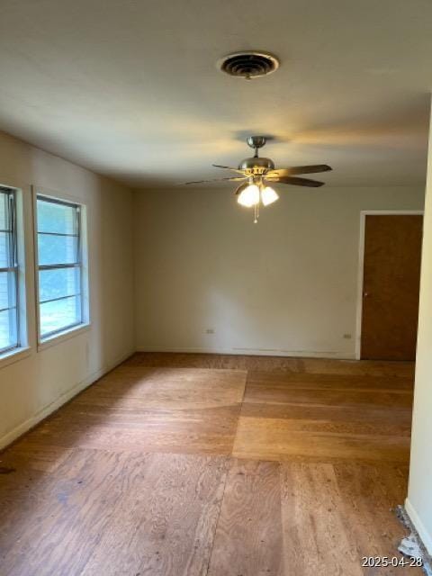 1912 18th St, Huntsville, TX 77340 - unfurnished room featuring light wood-style floors, a ceiling fan, and baseboards