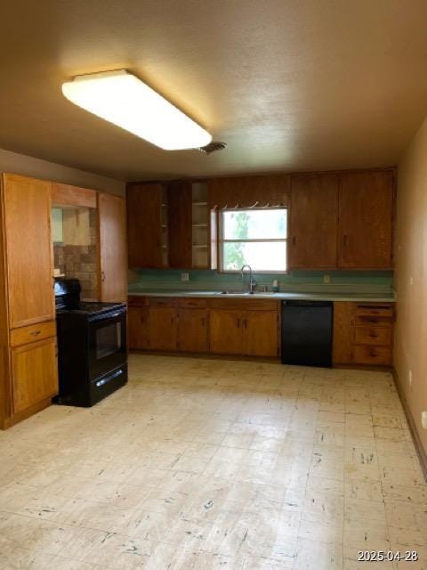 1912 18th St, Huntsville, TX 77340 - kitchen with black appliances, brown cabinets, and a sink