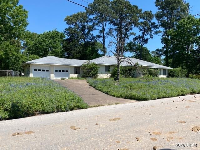 1912 18th St, Huntsville, TX 77340 - ranch-style home with an attached garage and asphalt driveway