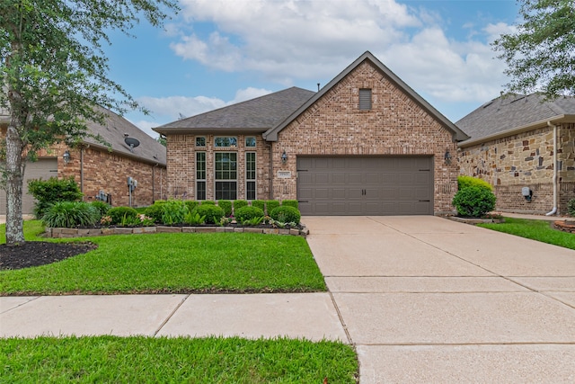 19303 Hamilton Hills Dr, Cypress, TX 77433 - view of front of home featuring brick siding, a garage, concrete driveway, a front yard, and roof with shingles