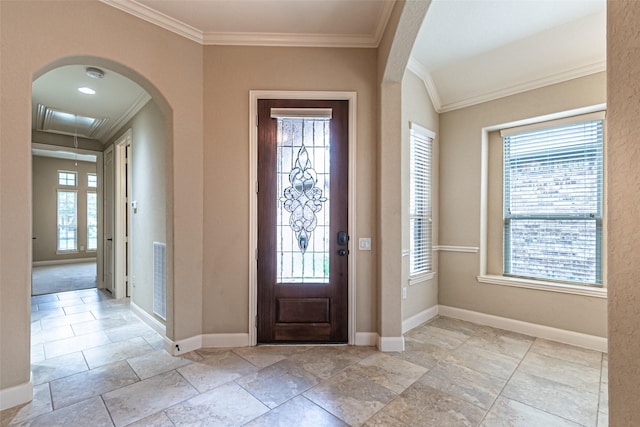 19303 Hamilton Hills Dr, Cypress, TX 77433 - entrance foyer featuring ornamental molding, baseboards, arched walkways, and stone tile flooring