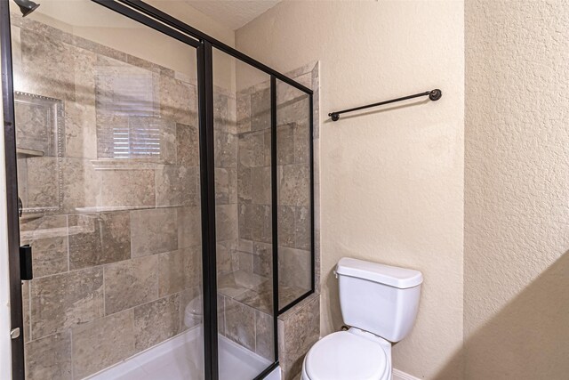 19303 Hamilton Hills Dr, Cypress, TX 77433 - bathroom featuring toilet, a textured wall, and a stall shower