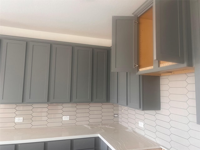 15198 Prairie Mill Dr, New Caney, TX 77357 - kitchen with gray cabinetry, backsplash, and light countertops