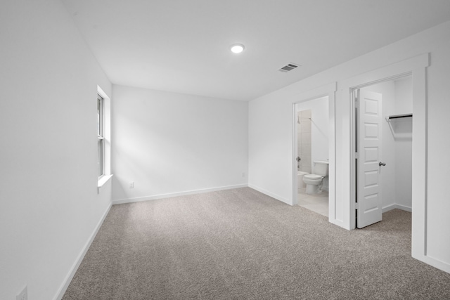 15198 Prairie Mill Dr, New Caney, TX 77357 - unfurnished bedroom featuring carpet, a walk in closet, recessed lighting, and connected bathroom