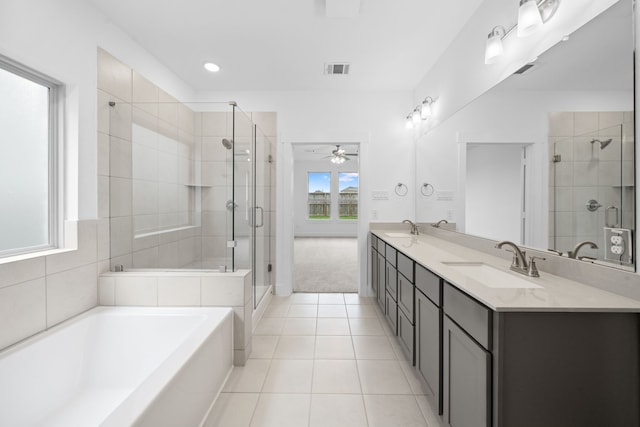 15198 Prairie Mill Dr, New Caney, TX 77357 - full bath featuring a garden tub, a stall shower, double vanity, tile patterned flooring, and a ceiling fan