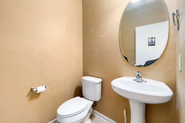 bathroom with toilet and a sink