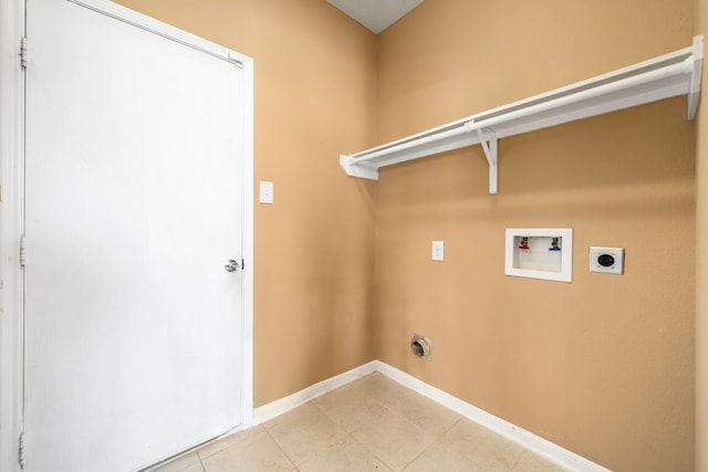 washroom with electric dryer hookup, baseboards, washer hookup, and light tile patterned flooring