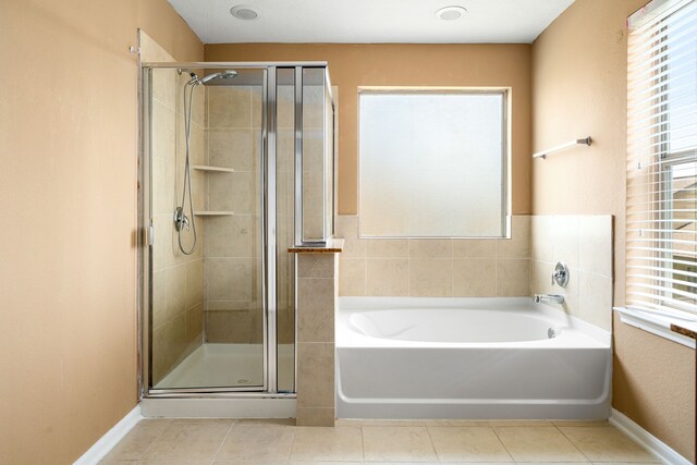 2706 Redwing Grove Way, Houston, TX 77038 - full bathroom featuring a shower stall, tile patterned flooring, a garden tub, and baseboards