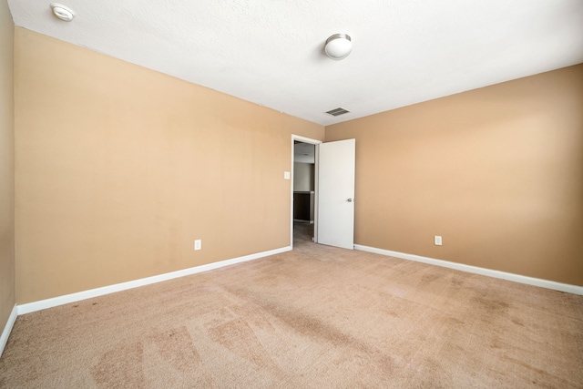 unfurnished room with carpet floors, baseboards, and a smoke detector