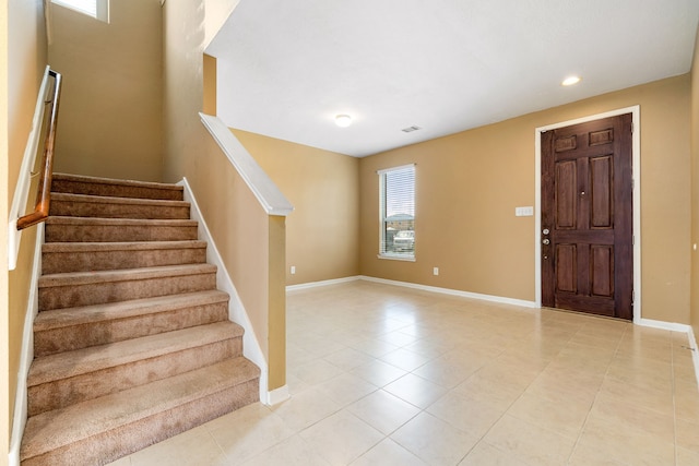 stairs with tile patterned floors, baseboards, and recessed lighting