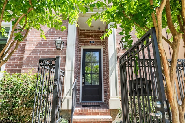 entrance to property featuring brick siding