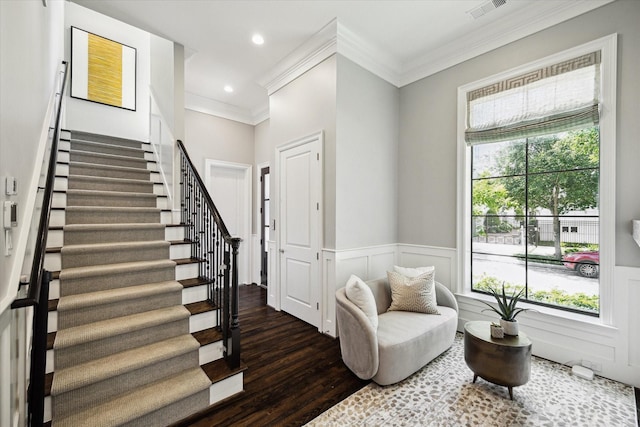 living area with stairway, wood finished floors, crown molding, a wainscoted wall, and recessed lighting