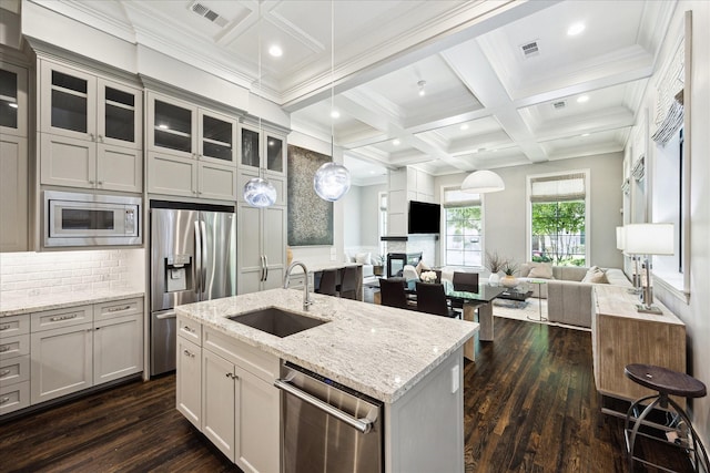 kitchen with appliances with stainless steel finishes, a sink, open floor plan, coffered ceiling, and dark wood-style floors