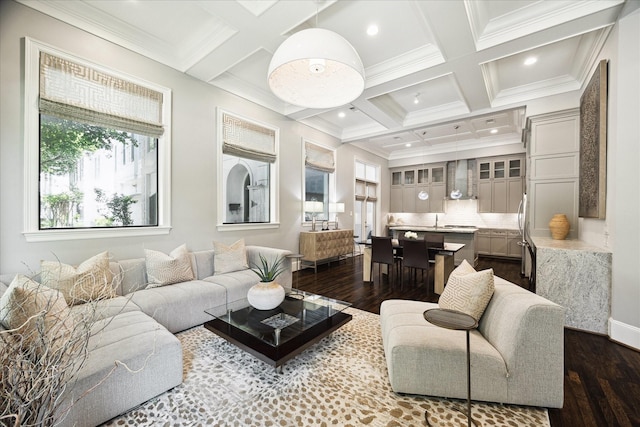 living area featuring coffered ceiling, dark wood finished floors, crown molding, beamed ceiling, and recessed lighting