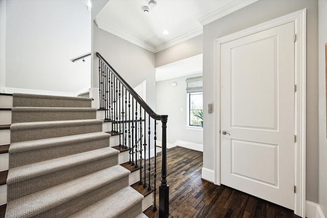 staircase with wood finished floors, crown molding, baseboards, and recessed lighting