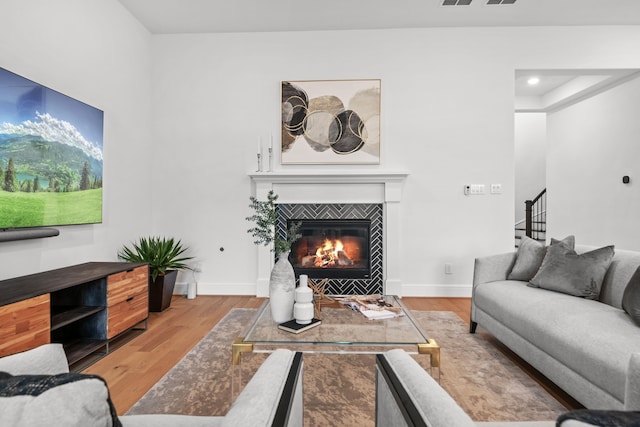5357 Cherry Spring Dr, Spring, TX 77386 - living area featuring wood finished floors, stairs, a tiled fireplace, and baseboards