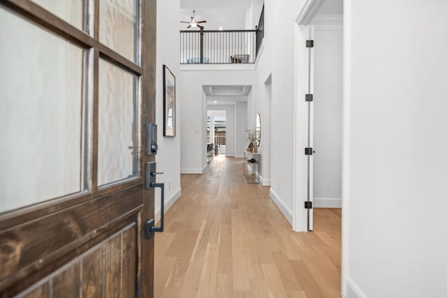 5357 Cherry Spring Dr, Spring, TX 77386 - entryway with light wood-style flooring, a ceiling fan, baseboards, and a towering ceiling