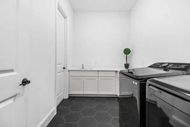 5357 Cherry Spring Dr, Spring, TX 77386 - washroom featuring independent washer and dryer, dark tile patterned flooring, and cabinet space