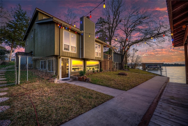 162 Ferncrest, Livingston, TX 77351 - view of front of house with a dock, a chimney, and a water view