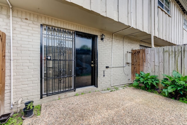 7938 Leonora St Unit B19, Houston, TX 77061 - doorway to property with brick siding, fence, and a patio area