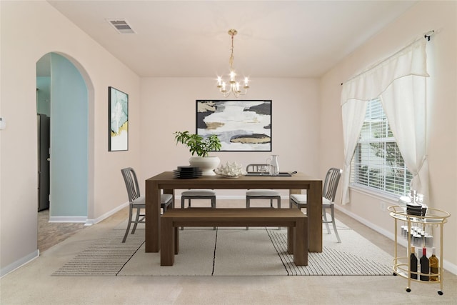 21514 Skyla Cir, Humble, TX 77338 - carpeted dining area with arched walkways, a chandelier, and baseboards