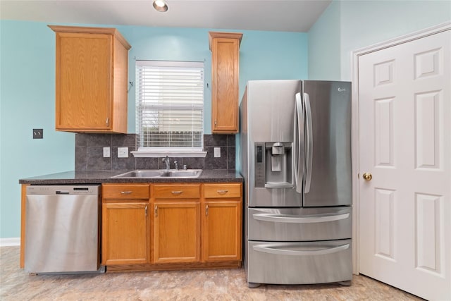 21514 Skyla Cir, Humble, TX 77338 - kitchen with stainless steel appliances, a sink, dark countertops, decorative backsplash, and brown cabinets