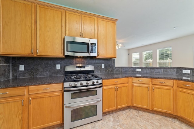 21514 Skyla Cir, Humble, TX 77338 - kitchen featuring stainless steel appliances, decorative backsplash, dark stone countertops, and ceiling fan