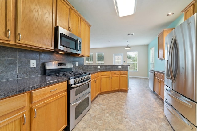21514 Skyla Cir, Humble, TX 77338 - kitchen with appliances with stainless steel finishes, tasteful backsplash, a peninsula, and dark countertops